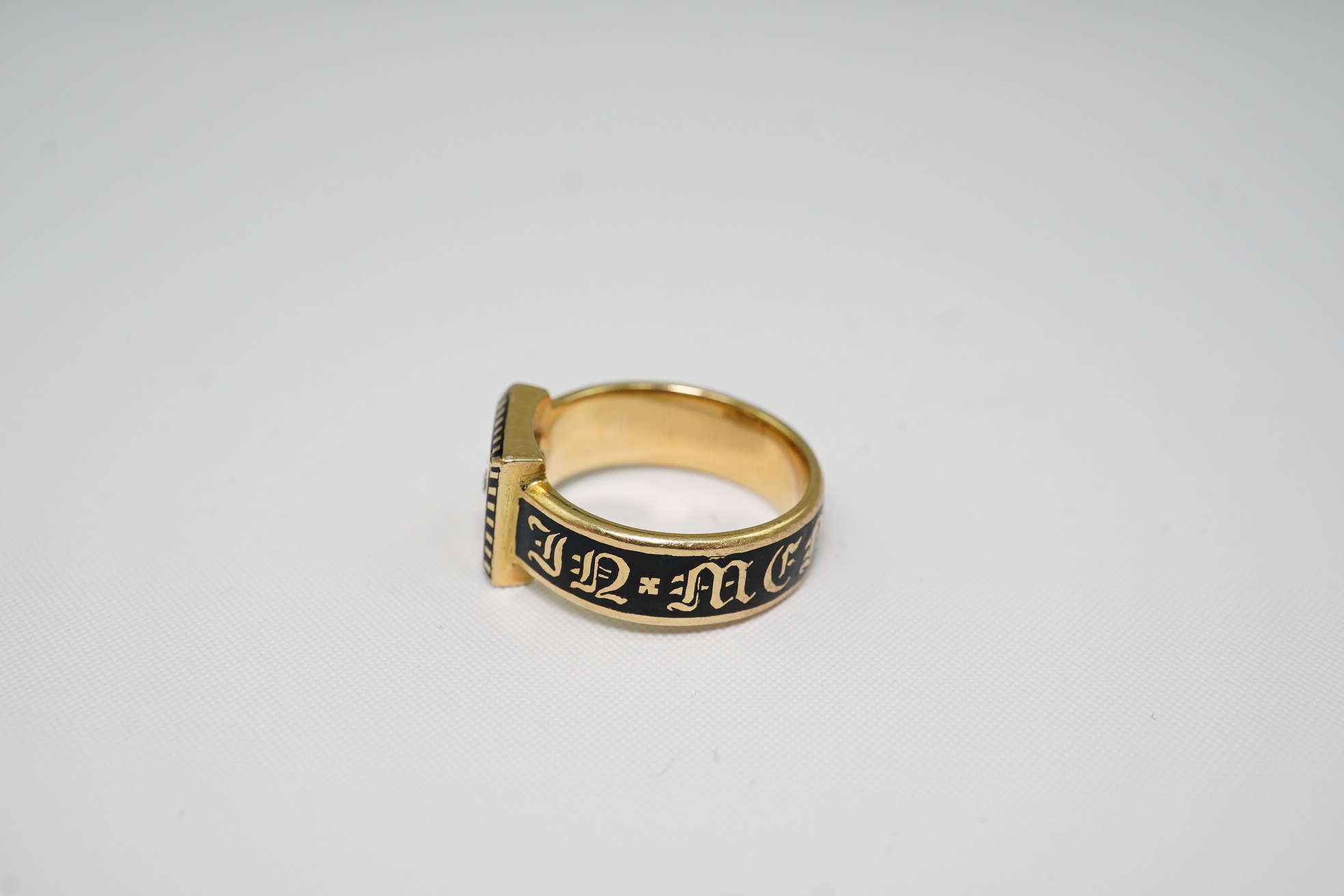 A 19th century 18ct gold, black enamel and single stone diamond set 'In Memory Of' ring